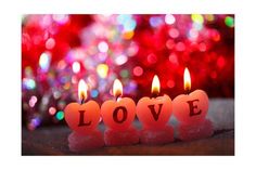 three candles with the word love written on them in front of a red and pink background