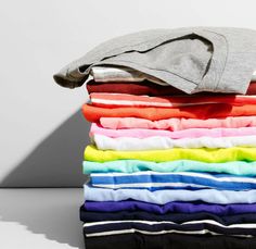 a stack of folded shirts sitting on top of each other