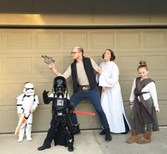 the family is dressed up as darth vader, princess lei lei and storm trooper