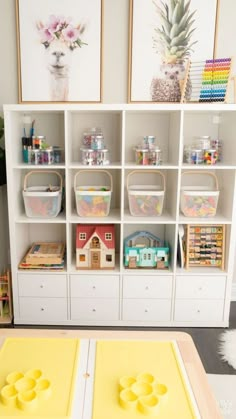 there are many toys in the playroom on this book shelf and it's colorful