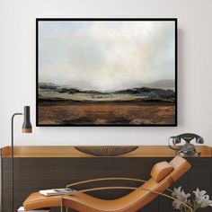 a painting hanging on the wall above a chair