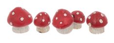 small red mushrooms with white dots on them are lined up in a row against a white background