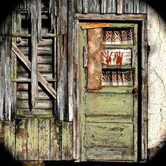 an old door is open on the side of a building