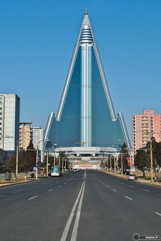 a very tall building sitting on the side of a road