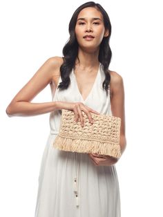 A lovely crochet pattern and festive fringe create a vibe that is well suited for the city or seaside. This clutch features cotton lining and snap closure. 11“W x 7“H- Approximate dimensions, each piece is handmade.
 Size: One Size Spring Bohemian Beige Crochet Bag, Beige Woven Clutch For Spring, Bohemian Woven Crochet Bag For Day Out, Spring Beige Woven Clutch, Beige Bohemian Clutch For Spring, Natural Cotton Crochet Bag For Spring, Rectangular Woven Clutch For Spring, Chic Woven Clutch For Spring, Chic Cream Clutch For Summer