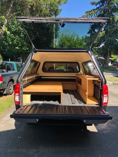 the back end of a pickup truck with an open trunk and storage compartment in it