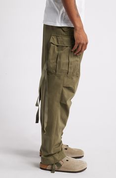 These rugged cargo pants inspired by original '60s fatigues with multiple pockets and functional zip ties offer functionality and style all at once. 17" leg opening; 12" front rise; 15" back rise 100% cotton Machine wash, tumble dry Imported Green Fits, Floral Shoes, Zip Ties, Mens Scarves, Scarf Men, Suit Accessories, Fabric Gift Bags, Rugby Shirt, Double Breasted Suit