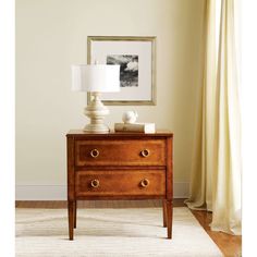 a wooden dresser with two lamps on top of it