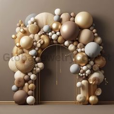 an arch made out of different types of balloons and other objects in gold, silver and white