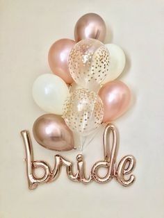 the bride balloon bouquet is shown in gold, white and pink balloons that spell out the word bride