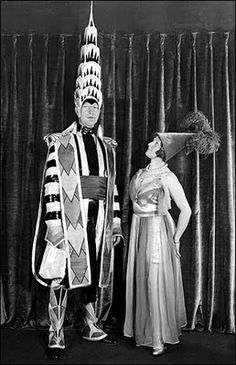 a man and woman in costume standing next to each other