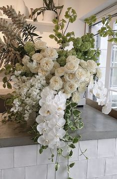 a bunch of flowers that are sitting on a counter