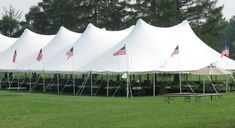 a row of white tents with american flags on them