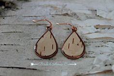 Eco-friendly genuine white birch bark earrings in copper, topped with clear resin. The ear wires are nickel free surgical steel. All of the bark used in our jewellery is ethically sourced and not harvested from live trees. The white birch we used comes from Northern Ontario Canada and carries within it, the energy of our Great Canadian Wilderness. Birch is believed to ward off evil, banish fears and build courage. Associated with beauty and tolerance, it heightens tolerance of oneself and others. The birch tree symbolizes a fresh start and can bring courage and determination to those of us who are treading the path of spiritual growth. These forest child earrings are set in copper. They measure approx 1 inch long. No two are alike due to the unique nature of birch bark. Birch Bark Earrings, Canadian Wilderness, Antler Earrings, Northern Ontario, Live Tree, White Birch, Unique Nature, Birch Bark, Kids Earrings