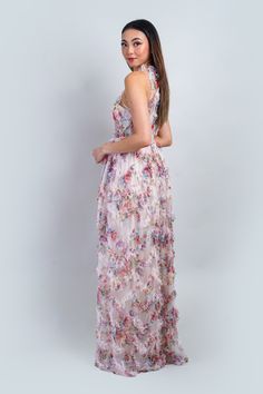 a woman in a long dress with flowers on it