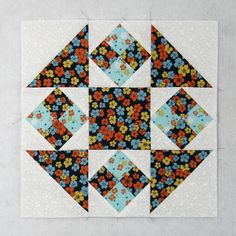 the block is made up of different colors and shapes, including blue, orange, yellow, and white flowers