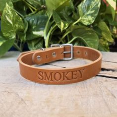 a leather dog collar with the word smokey engraved on it's front side