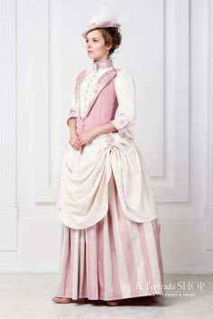 ONLY TO ORDER 4-6 weeks 1870-1880'ss historical woman's costum in victorian epoch style second part of 19th century pink and white color. It will be perfect for historical festival, photosession, steampunk event or theatre performance. Costume consist of 3 separated parts: bodice and 2 skirts - underskirt and top skirt with folds and ruffles. Hard bodice from 3 different kind of fabric with line of buttons in front. Decorated with lace on the lapels and cuffs. Skirt from striped cloth with folds 1870s Day Dress, 19th Century Dress, Moda Steampunk, Victorian Era Dresses, Mode Steampunk, Walking Dress, Steampunk Dress, Bustle Dress, Historical Women