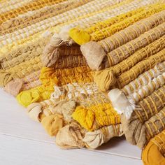 a pile of yellow and brown knitted rugs