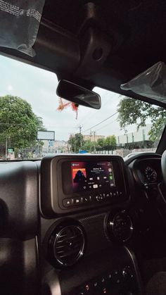 the interior of a vehicle with dashboard, radio and steering wheel view from driver's seat