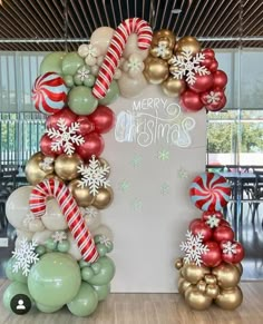 a christmas balloon arch with candy canes and snowflakes