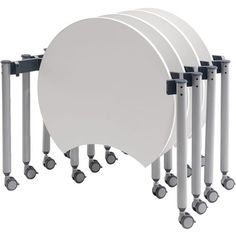 six white round tables with wheels on each side