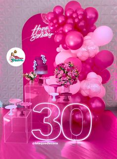 a pink birthday party with balloons, cake and flowers on the table for someone's 30th birthday