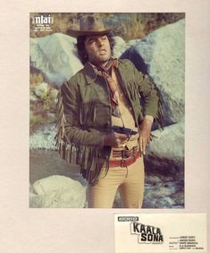 a man in a cowboy outfit standing next to rocks