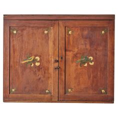 an old wooden cabinet with flowers painted on the front and side doors, isolated against a white background