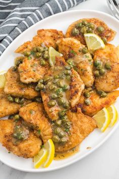 chicken with peas and lemon on a white plate