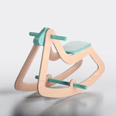 a wooden rocking toy with a green seat