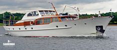 a large white and brown boat in the water