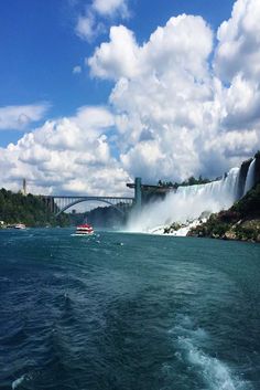 a boat is in the water next to a bridge and a large body of water