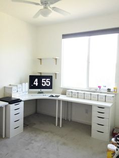 a white desk with drawers and a computer on it