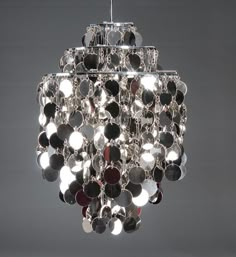 a chandelier hanging from the ceiling with lots of buttons on it's sides