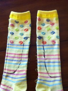 two pairs of colorful socks sitting on top of a wooden floor