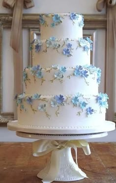 a wedding cake with blue flowers on it