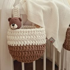 a crocheted basket with a teddy bear in it and a blanket on top