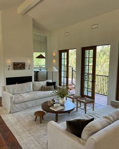 a living room filled with furniture and a fire place in the middle of a room