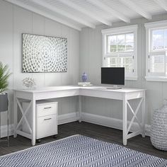 a white desk sitting in the corner of a room