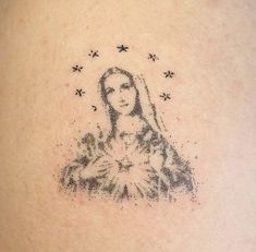 a woman's back tattoo with the image of mary and stars above her head