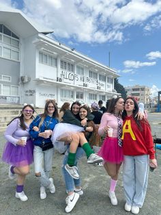 the girls are posing together in front of a building