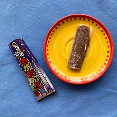 a plate with a piece of food on it next to a candy bar