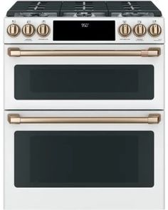 two white and gold ovens side by side