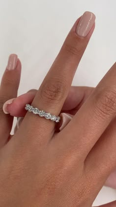 a woman's hand with a diamond ring on it