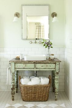 a bathroom with a sink, mirror and basket