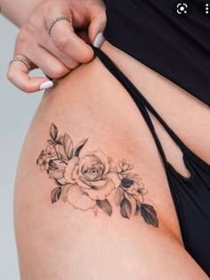 a close up of a woman's stomach with tattoos on her belly and flowers