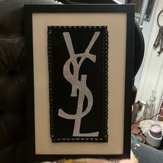 a black and white picture with the word y on it in front of a chair