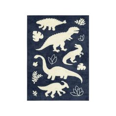 a blue rug with white dinosaurs and leaves on the ground, in front of a white background