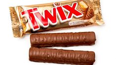 two chocolate candy bars next to each other on a white surface with the word twix printed on it